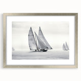 Abstract art print of a stylized sailboat in silver, blue, and white tones on a framed canvas.