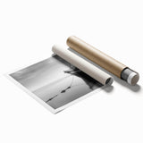 Rolled print of a sailboat on calm waters under a clear sky, in muted blue and white tones, ideal for bathroom wall decor.