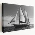 Sailboat on a calm sea depicted in soft blue and white tones on a stretched canvas, ideal for kitchen wall art.