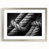 Abstract art print of a stylized sailboat in muted blue and gray tones on a silver-framed canvas.