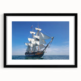 Abstract art print of a vibrant, colorful ship on textured canvas, framed in black, ideal for living room decor.