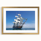 Textured art of an abstract boat in muted blue and gray, acrylic print framed in gold, suitable for bedroom decor.