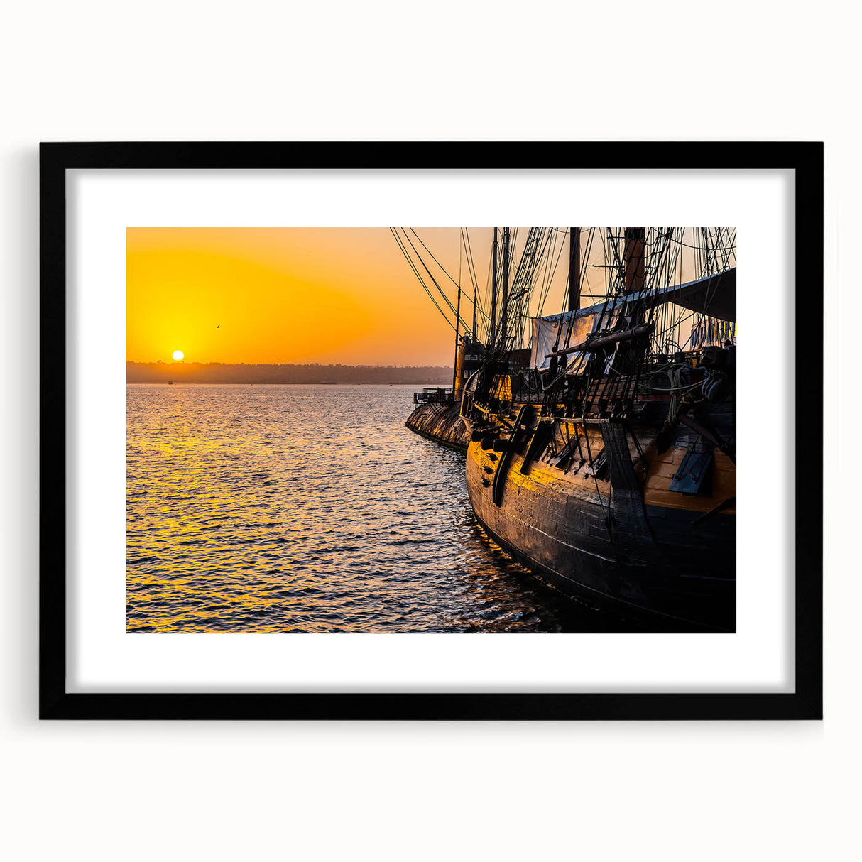 Abstract art print featuring a colorful, textured depiction of ships, in a black frame with mat, ideal for living room decor.