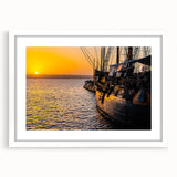 Abstract art print of a textured ship in muted blue and white, framed with a white mat.