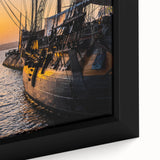 Framed canvas featuring a large black ship on a textured, colorful abstract background, ideal for living room decor.