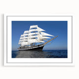 Abstract art print of a stylized ship in muted gray and blue tones on white framed canvas.