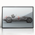 A large abstract wall art print featuring race cars in motion, using bold black and red colors on a framed acrylic.
