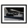 Abstract art print of race cars in vibrant, colorful strokes on a large black framed canvas, suited for living room decor.