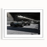 Abstract art print of race cars in motion, using blurred lines and vibrant colors, framed with a white mat.