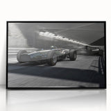 Large abstract wall art featuring a dynamic race car scene in vibrant red and blue tones on a black acrylic framed print.