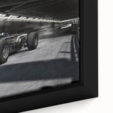 Extra large framed canvas of colorful race cars in motion on a textured black background, ideal for living room decor.