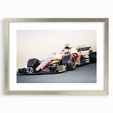 Textured art print depicting abstract race cars in neutral gray tones on a framed silver mat, suitable for bedroom decor.