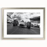 Textured art print featuring abstract race cars in vivid red and orange tones on a silver framed canvas.
