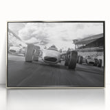 Mid-century modernist race cars in dynamic motion, acrylic print in silver frame, vibrant colors.