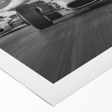 Art deco poster featuring a scene of vintage race cars in vibrant red and blue tones on rolled canvas.