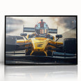 Large abstract wall art depicting race cars in motion, using bright primary colors on a black acrylic framed print.