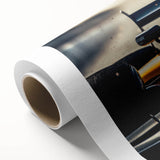 Art deco poster featuring race cars in bold red and black on rolled canvas.