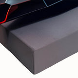 Black and white photo of sports cars in motion on a race track, printed on large stretched canvas.