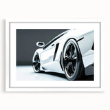 Abstract art print of a stylized sports car in vibrant red and black tones, framed with a white mat.