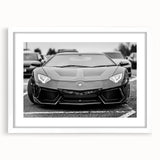 Abstract art print of a stylized sports car in bold red and black tones on a white framed canvas.