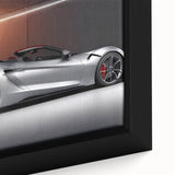 Close-up of a black canvas featuring a textured, colorful abstract design of sports cars.