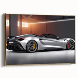 Side view of a vintage sports car in black and gold on a framed canvas, suitable as wall art for a bedroom.