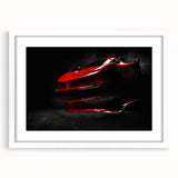 Abstract art print of a stylized sports car in vibrant red and black tones on a white framed canvas.