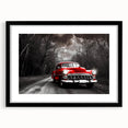 Abstract art print featuring a colorful, textured depiction of a taxi, in a large black frame with mat.