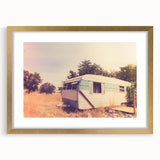 Abstract caravan in textured art style with muted earth tones on a gold-framed mat, ideal for bedroom art.