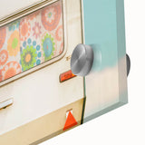 Large abstract wall art on acrylic glass depicting a mid-century modernist caravan, in muted earth tones.