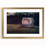 Textured abstract art print of a caravan in gold tones on a framed canvas, suitable for bedroom decor.