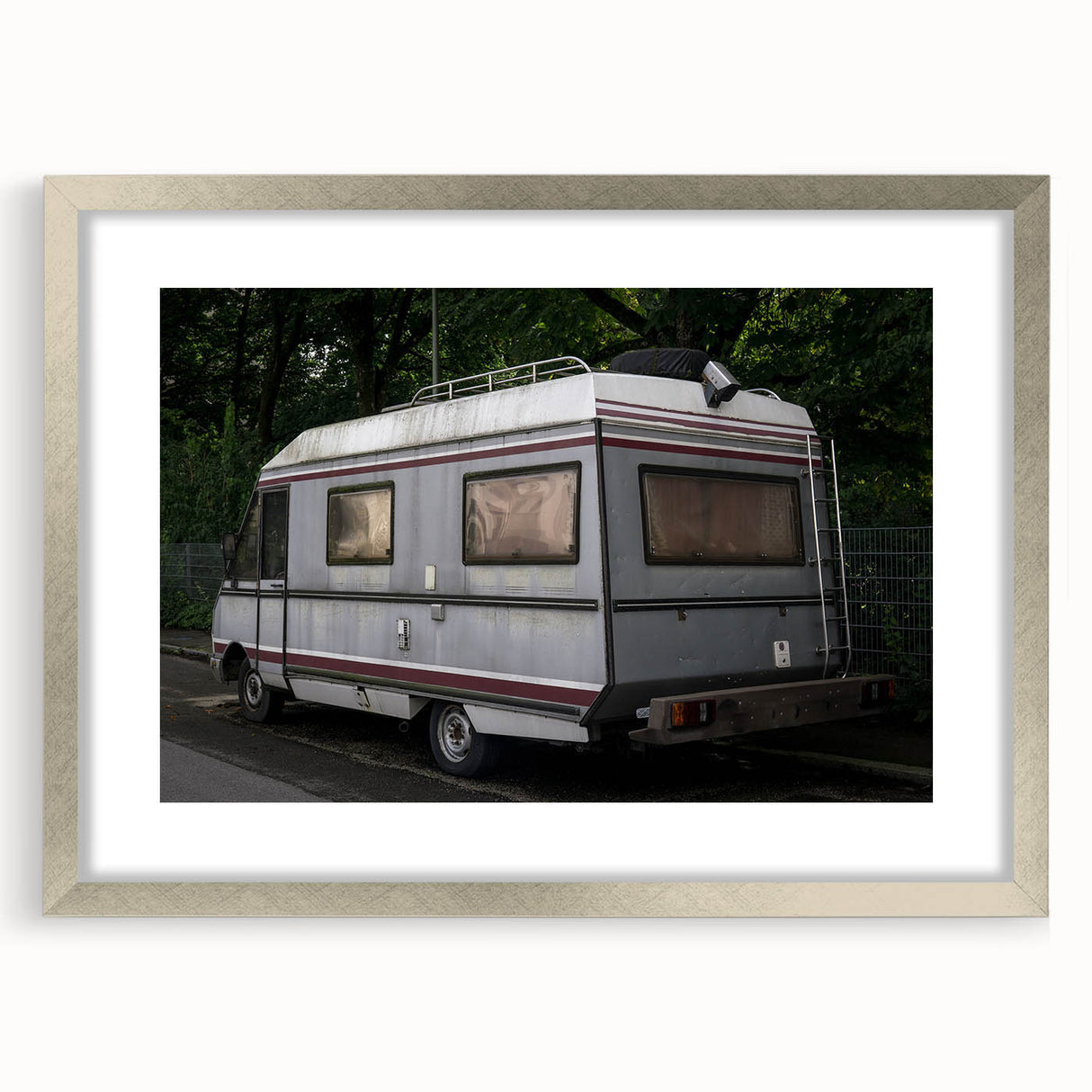 Abstract art print of a caravan in muted earth tones on a framed silver mat, ideal for dining room decor.
