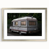 Abstract art print of a caravan in muted earth tones on a framed silver mat, ideal for dining room decor.