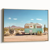 Framed canvas depicting a vintage caravan in a landscape setting, rendered in black and gold tones.