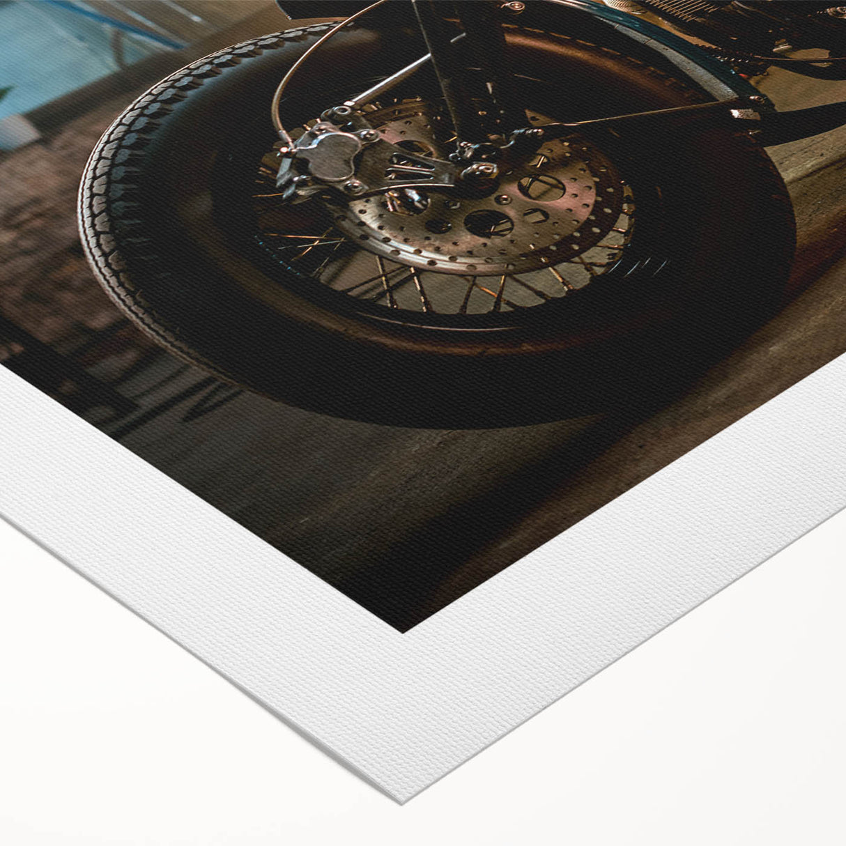 Art deco poster of a classic motorcycle in black and gray tones on a rolled canvas.