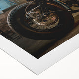 Art deco poster of a classic motorcycle in black and gray tones on a rolled canvas.
