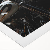 Art deco poster of a classic motorcycle in black and white tones on rolled canvas.