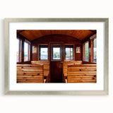 Abstract textured art print of service vehicles in muted grays and blues on a framed silver mat, suitable for bedroom decor.