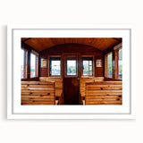 Abstract art print of colorful service vehicles on a white framed poster, suitable for dining room decor.