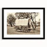 Abstract art print of colorful, textured vehicles on a large canvas, framed in black, ideal for living room decor.