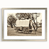 Textured art print of abstract service vehicles in muted grays and blues, framed in silver, ideal for bedroom decor.