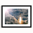 Abstract art print of colorful, textured spacecraft design in a black frame with mat.