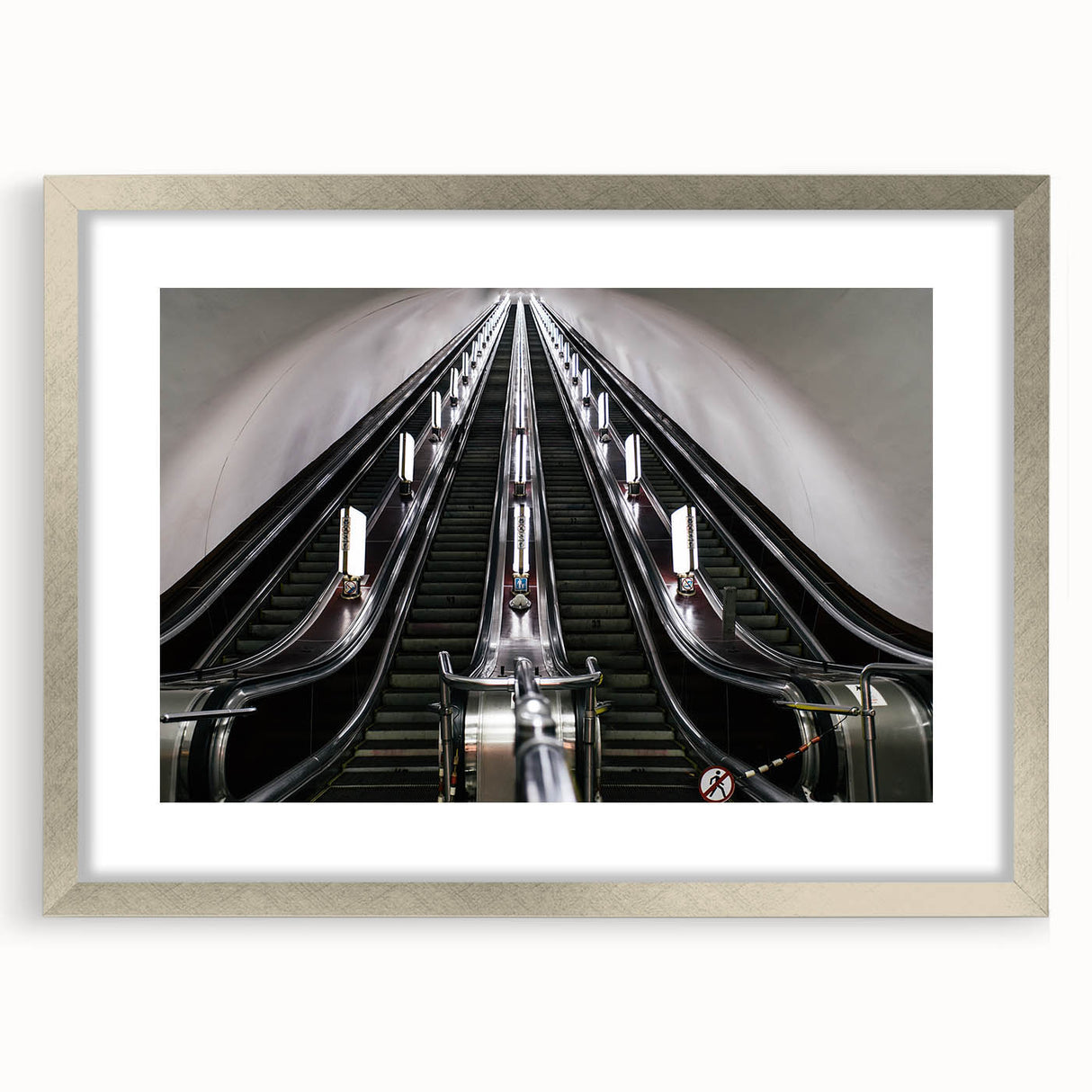 Textured art print of an abstract subway design in muted grays and blues, framed in silver.