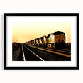 Abstract art print of a colorful train, featuring textured brush strokes on a large black-framed canvas.