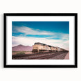 Abstract art print of a colorful, textured train, in a black frame with mat, ideal for living room decor.