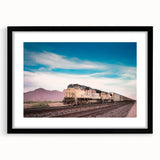 Abstract art print of a colorful, textured train, in a black frame with mat, ideal for living room decor.