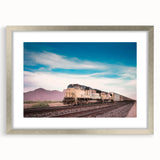 Textured abstract art print of a train in muted gray and blue tones, framed in silver, ideal for bedroom wall decor.