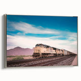 Framed canvas featuring a vintage train in black with colorful landscape background.