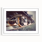 Abstract art print of a stylized train in muted gray and blue, framed with a white mat.