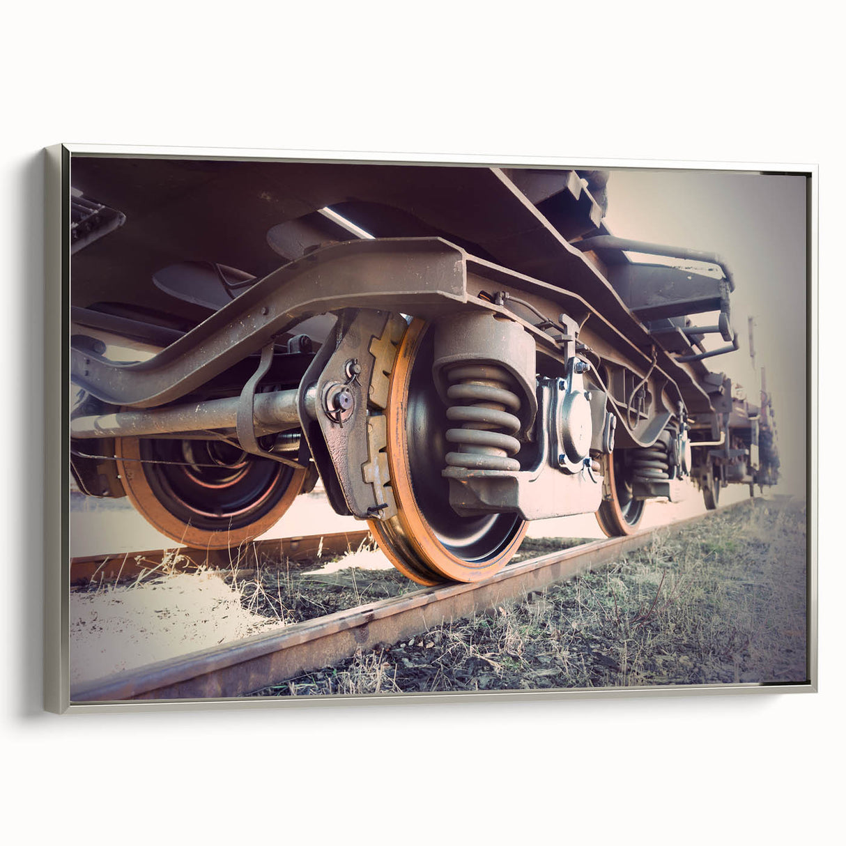 Vintage poster-style landscape art painting of a train, rendered in black with colorful accents, framed in silver canvas.
